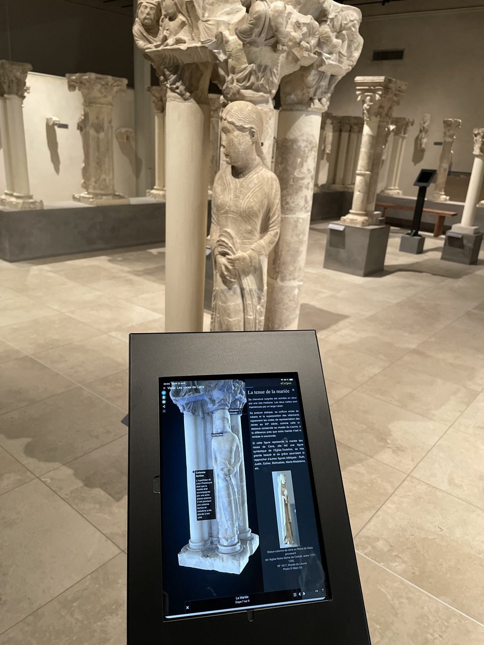 The tablet presenting an eCorpus scene serves as a digital label for a lapidary work